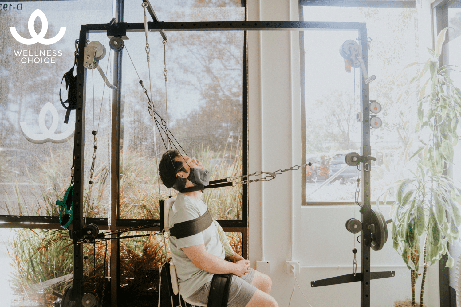 Patient receiving corrective spinal traction for posture assessment and rehabilitation at Wellness Choice in Costa Mesa, California